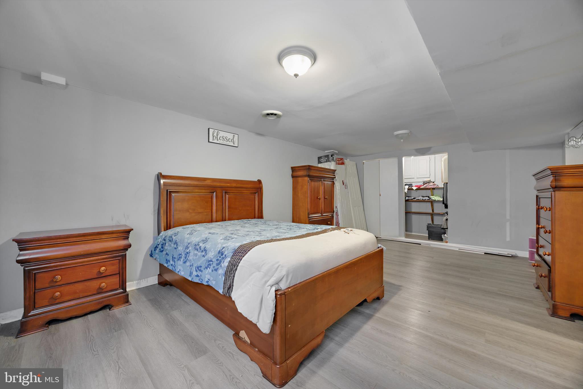 5401 Kenmont Road Oxon Hill, MD 20745 - Photo 29 of 39 a bedroom with a bed and a flat tv screen on dresser