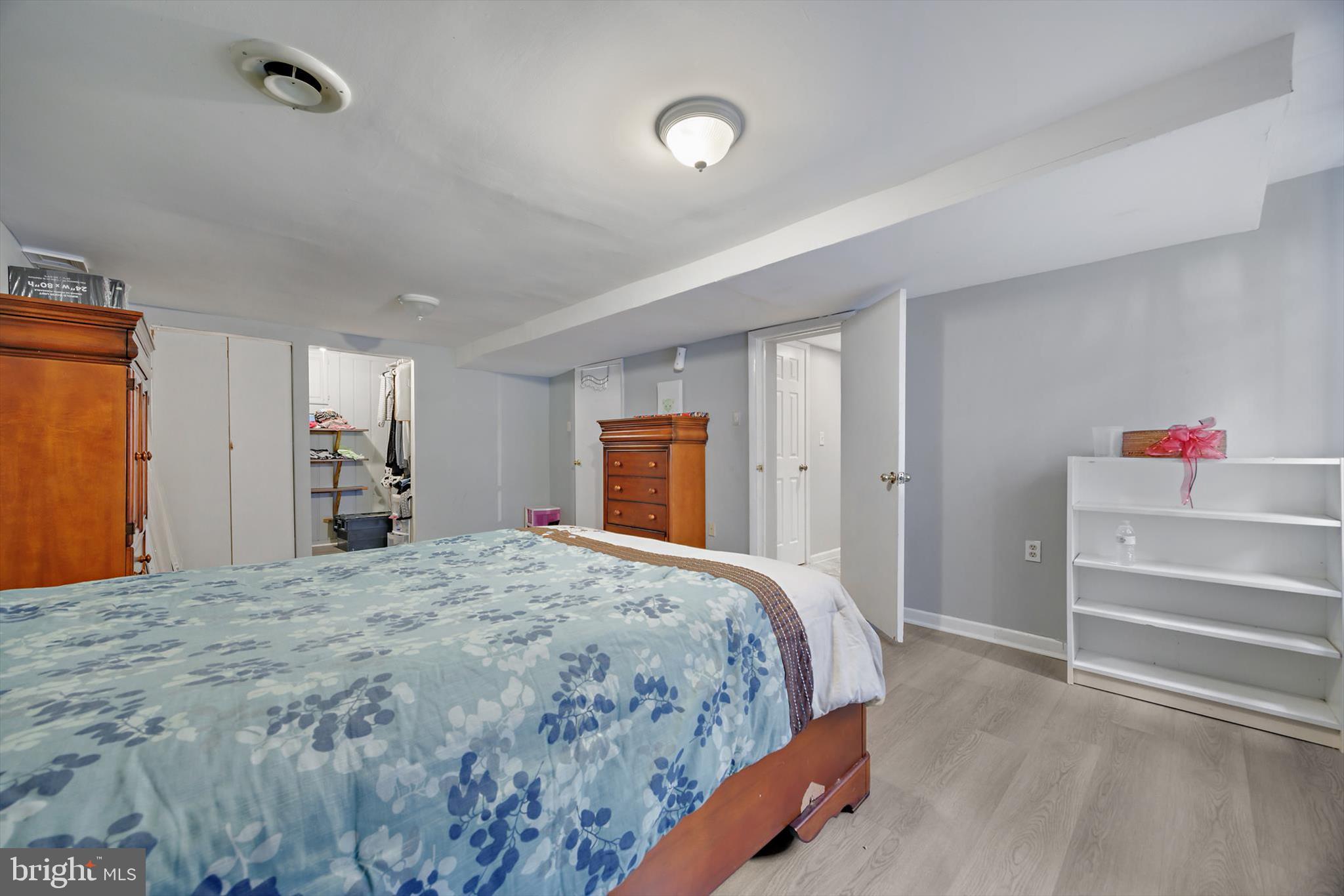 5401 Kenmont Road Oxon Hill, MD 20745 - Photo 30 of 39 a bedroom with a bed and a walk in closet