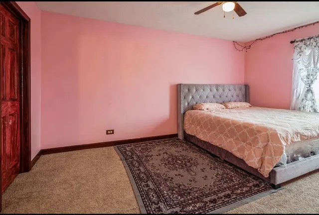 a bedroom with a bed and a rug