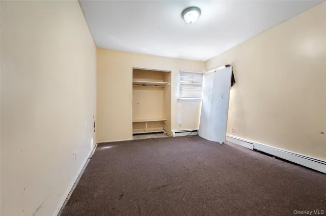 an empty room with closet area