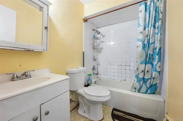 a bathroom with a sink a toilet a mirror and shower