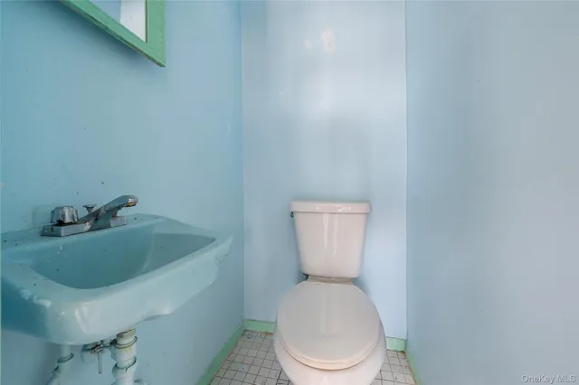 a white toilet sitting next to a bathroom sink