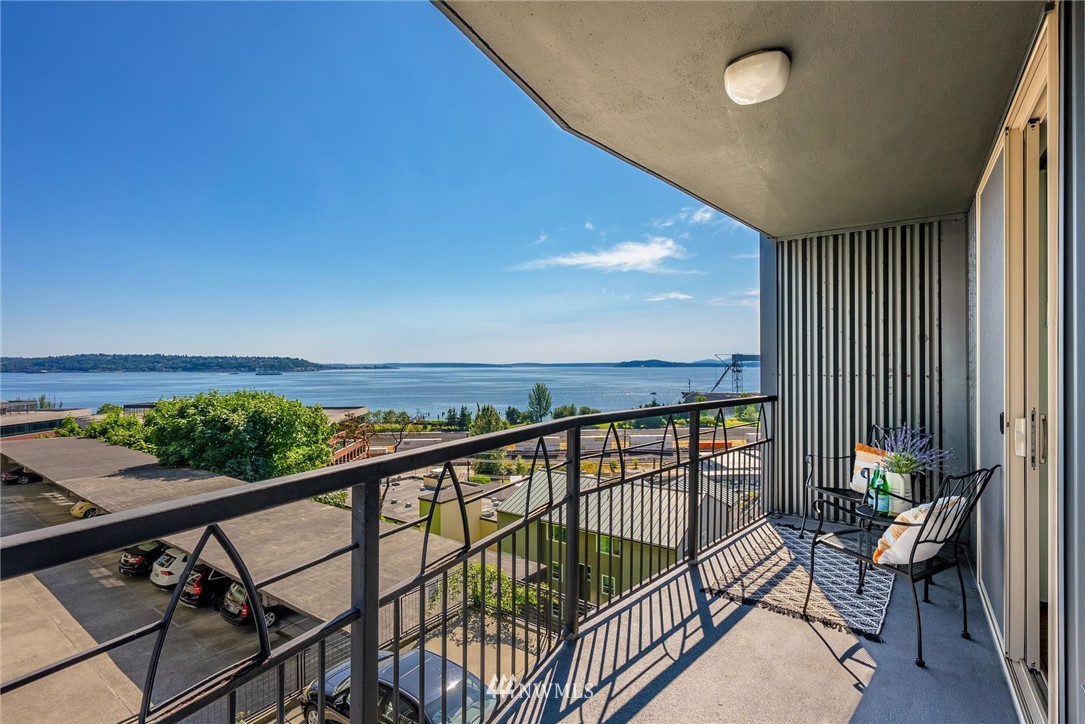507 West Mercer Street, Unit 603 Seattle, WA 98119 - Photo 1 of 21 a view of a balcony with chairs and wooden floor