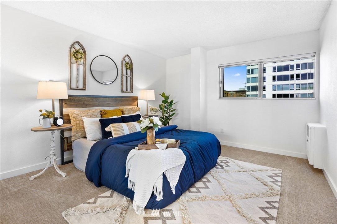 507 West Mercer Street, Unit 603 Seattle, WA 98119 - Photo 11 of 21 a bedroom with a bed and wooden floor