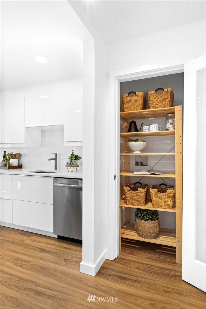507 West Mercer Street, Unit 603 Seattle, WA 98119 - Photo 16 of 21 a kitchen with a refrigerator and white cabinets