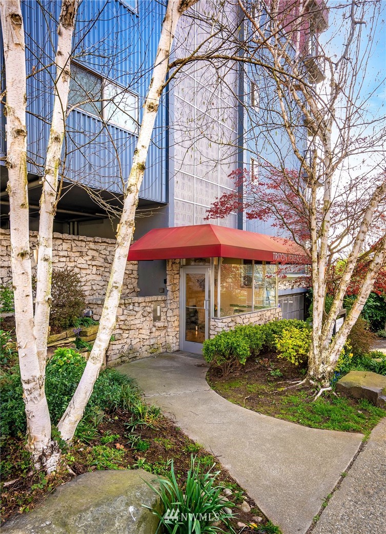 507 West Mercer Street, Unit 603 Seattle, WA 98119 - Photo 19 of 21 a front view of a house with a garden and trees