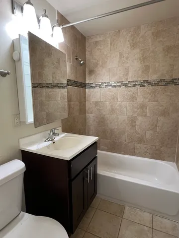 a bathroom with a sink mirror toilet and bathtub