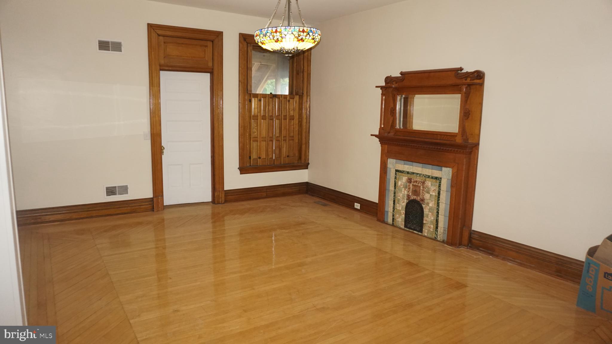 200 East Walnut Street, Unit 1 Hanover, PA 17331 - Photo 11 of 29 a view of an empty room with a fireplace and a window