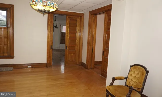 a view of a hallway with entryway wooden floor and front door