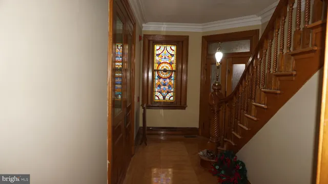 a view of a hallway with wooden walls and entryway