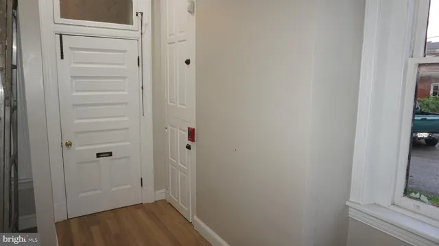 a view of a hallway with wooden floor