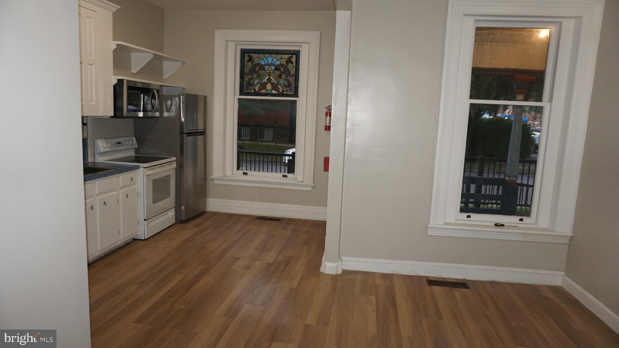 200 East Walnut Street, Unit 1 Hanover, PA 17331 - Photo 10 of 29 wooden floor in an empty room and a window