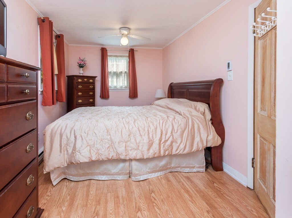 97 Sandy Beach Road Holland, MA 01521 - Photo 27 of 41 a bed sitting in a bedroom and tv on dresser