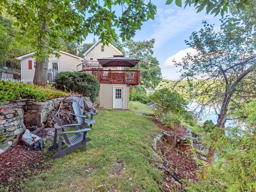 97 Sandy Beach Road Holland, MA 01521 - Photo 9 of 41 a view of a chair and table in the garden
