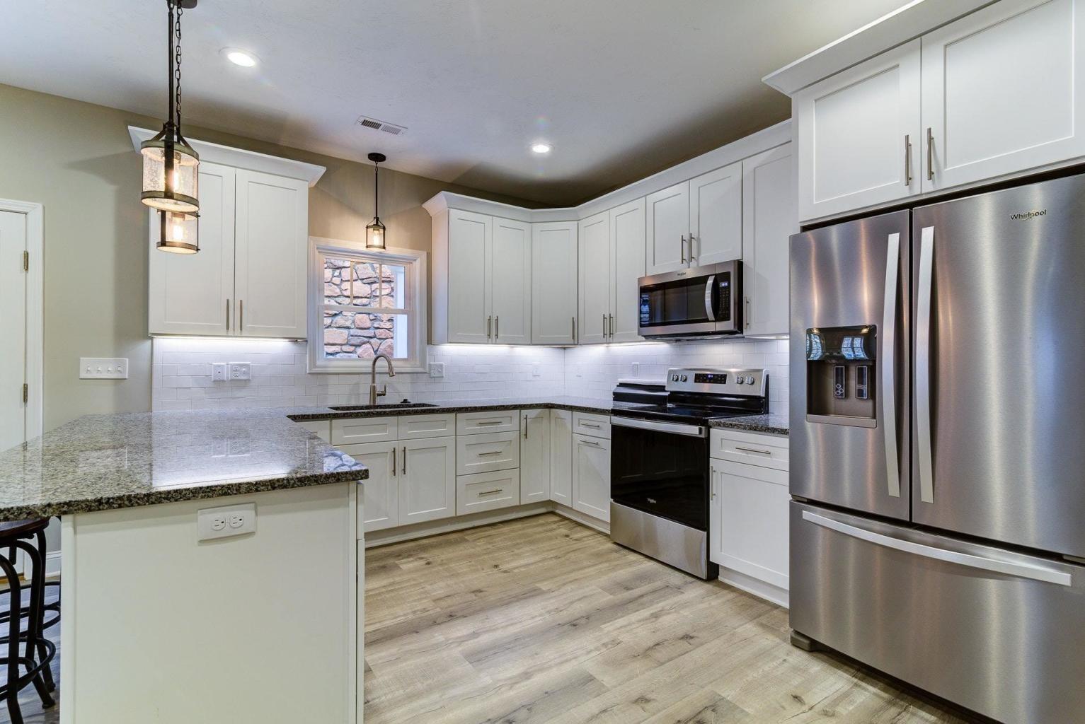 4257 Daugherty Road Salem, VA 24153 - Photo 11 of 37 a kitchen with granite countertop a refrigerator stove top oven and sink