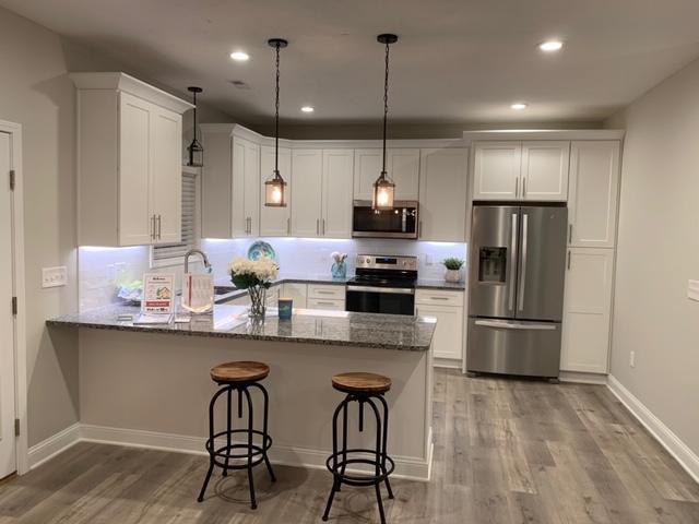 4257 Daugherty Road Salem, VA 24153 - Photo 12 of 37 a kitchen with stainless steel appliances a dining table chairs refrigerator and microwave