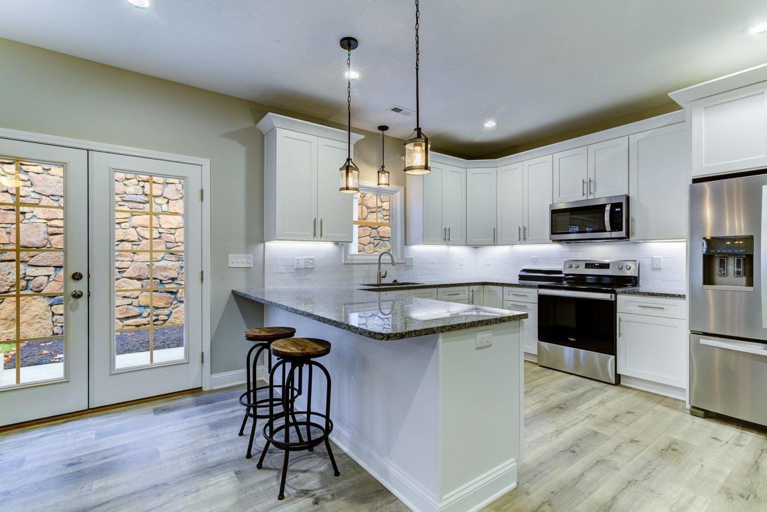 4257 Daugherty Road Salem, VA 24153 - Photo 13 of 37 a kitchen with kitchen island granite countertop wooden floors and appliances