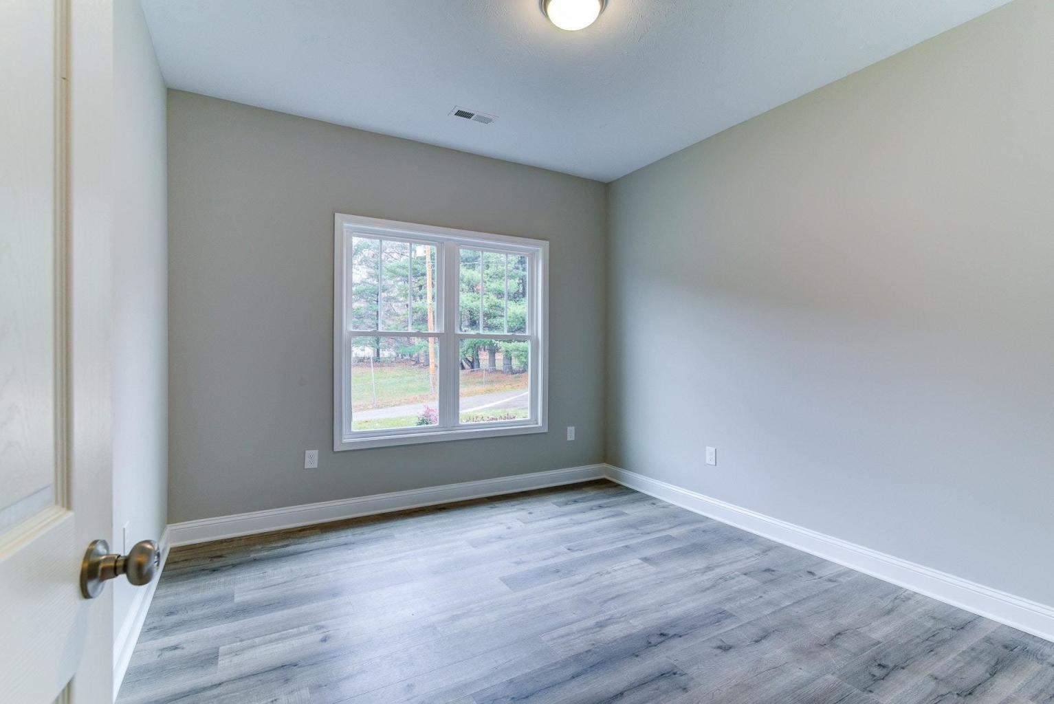 4257 Daugherty Road Salem, VA 24153 - Photo 17 of 37 an empty room with wooden floor and a window