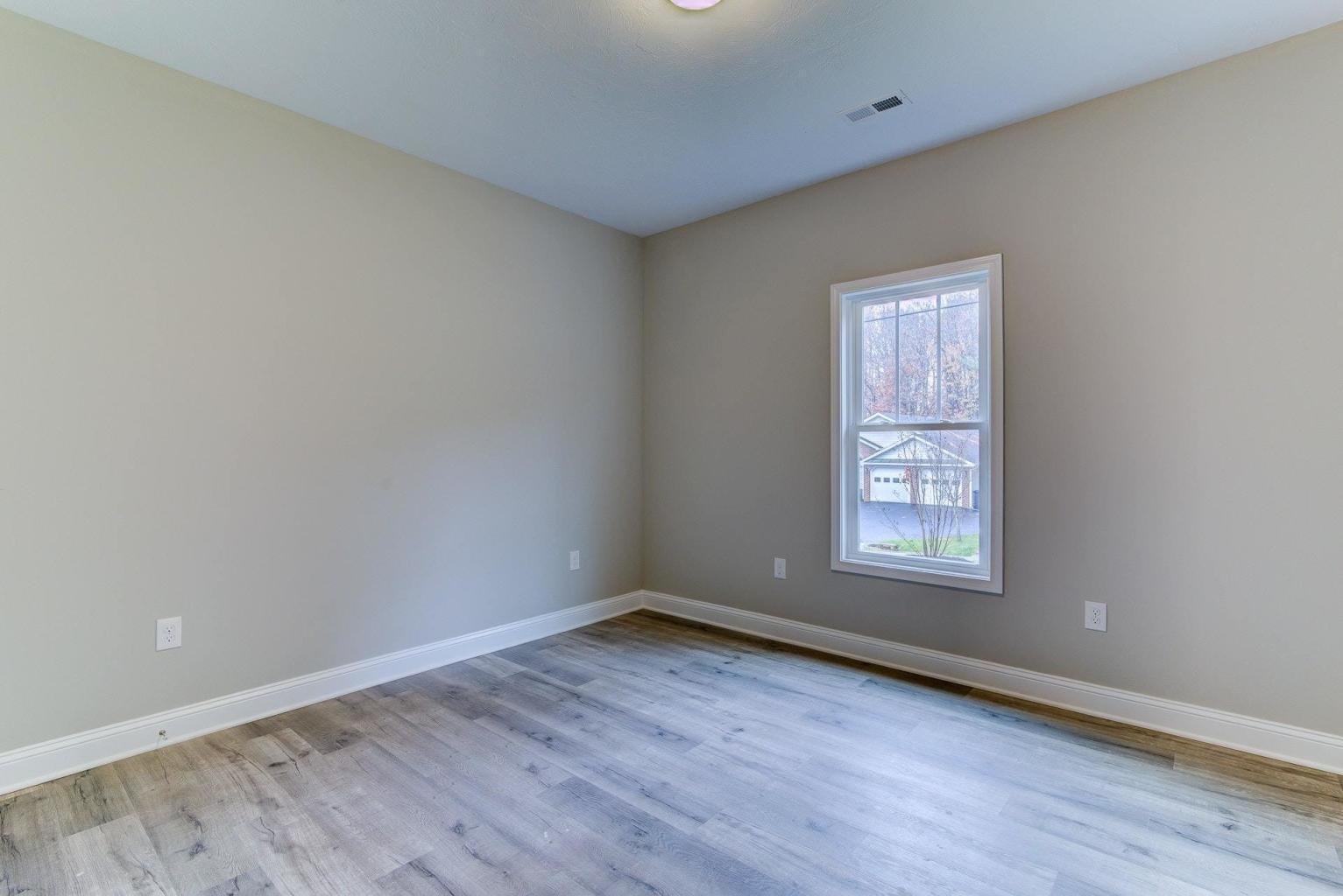 4257 Daugherty Road Salem, VA 24153 - Photo 18 of 37 an empty room with wooden floor and windows