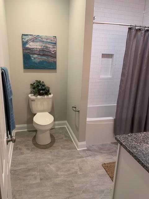4257 Daugherty Road Salem, VA 24153 - Photo 19 of 37 a bathroom with a granite countertop sink toilet and a bathtub