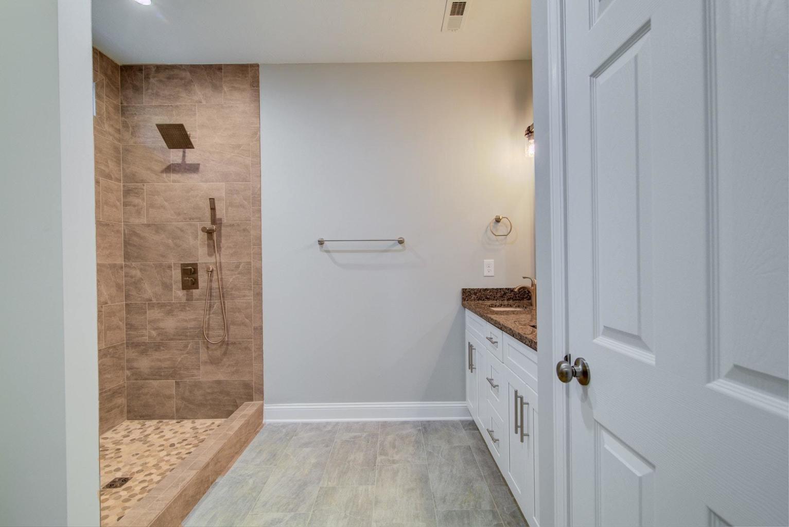 4257 Daugherty Road Salem, VA 24153 - Photo 26 of 37 a bathroom with a granite countertop sink a mirror and shower
