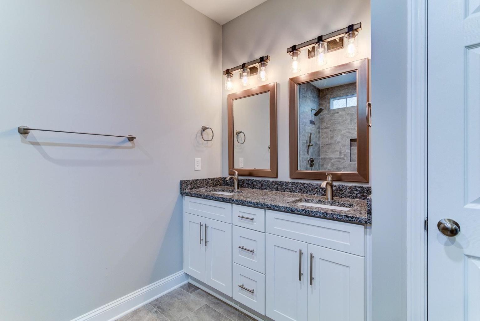 4257 Daugherty Road Salem, VA 24153 - Photo 28 of 37 a bathroom with a granite countertop sink and a mirror