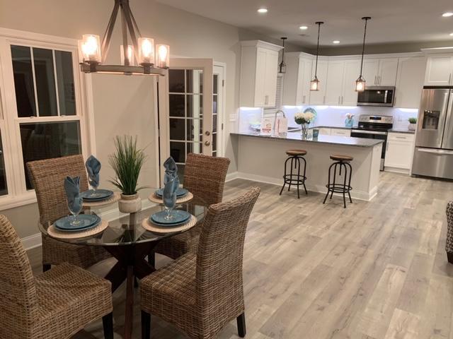 4257 Daugherty Road Salem, VA 24153 - Photo 10 of 37 a open dining room with stainless steel appliances kitchen island granite countertop a table chairs and a refrigerator