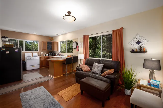a living room with furniture fireplace and a large window