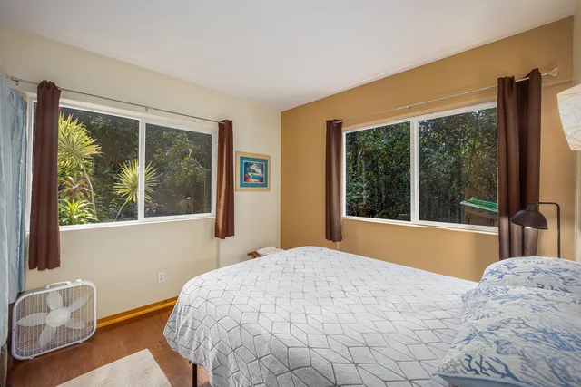a bedroom with a bed and glass window