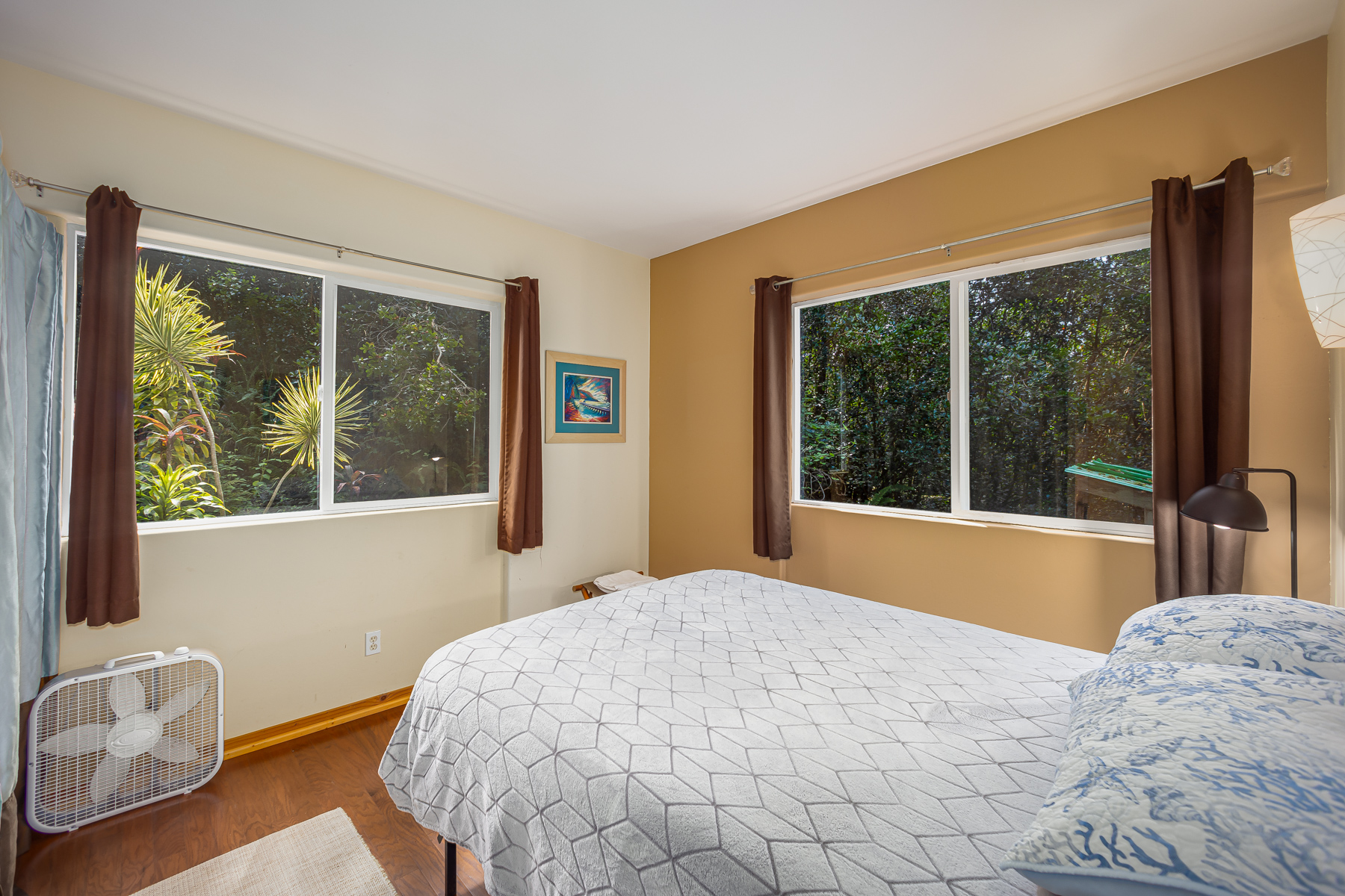 87-2500 Luana Way Captain Cook, HI 96704 - Photo 19 of 30 a bedroom with a bed and glass window