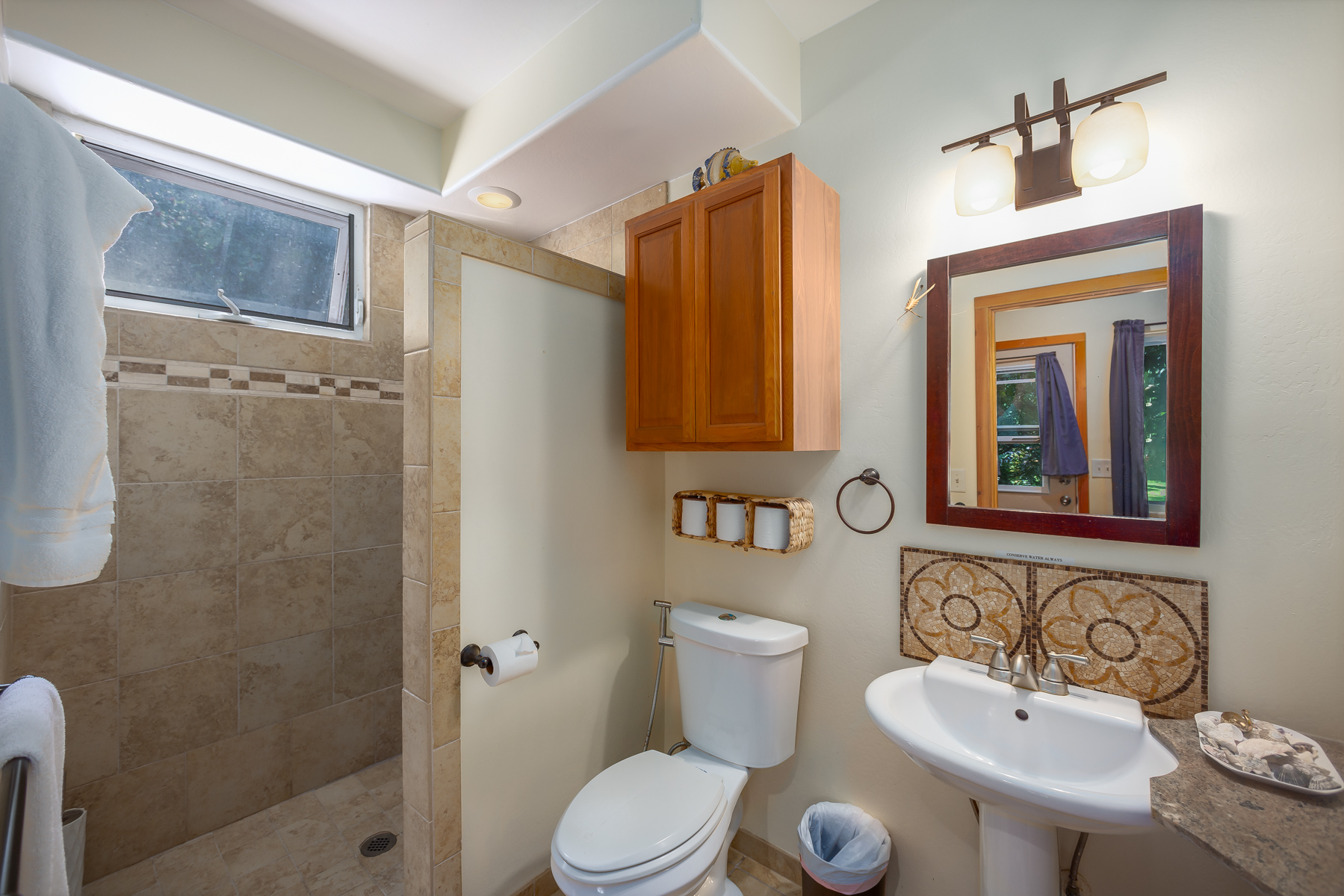 87-2500 Luana Way Captain Cook, HI 96704 - Photo 20 of 30 a bathroom with a toilet sink shower and mirror