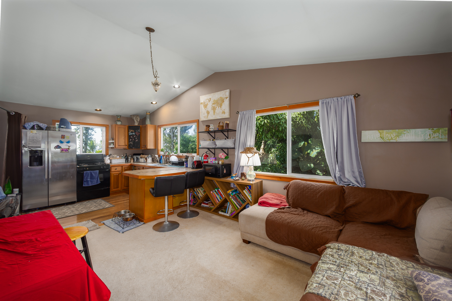 87-2500 Luana Way Captain Cook, HI 96704 - Photo 22 of 30 a living room with furniture a large window and a chandelier