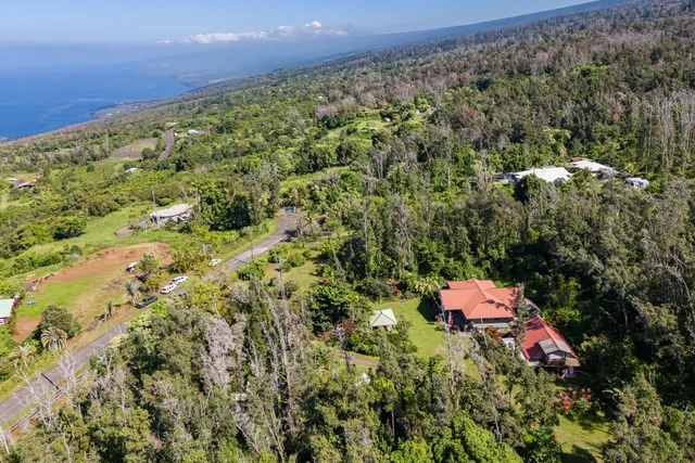 an aerial view of a houses with a yard