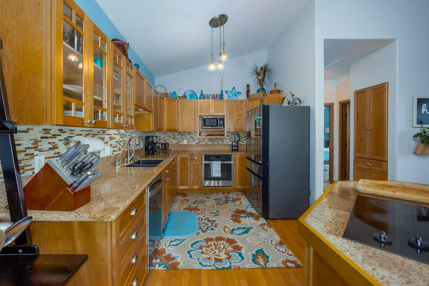 87-2500 Luana Way Captain Cook, HI 96704 - Photo 4 of 30 a kitchen with stainless steel appliances granite countertop a sink stove and refrigerator