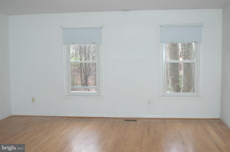 9914 Meadowlark Road Vienna, VA 22182 - Photo 6 of 10 an empty room with windows