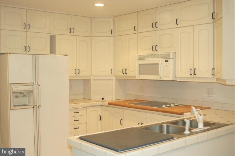 9914 Meadowlark Road Vienna, VA 22182 - Photo 7 of 10 a view of a kitchen with white cabinets