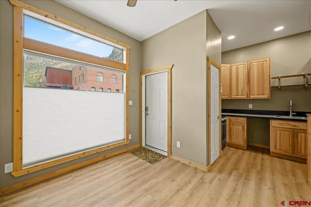 a view of kitchen with stainless steel appliances granite countertop a refrigerator and a stove top oven