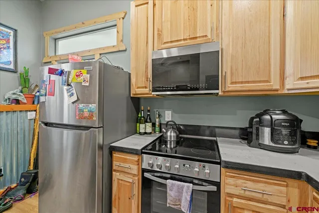 a kitchen with stainless steel appliances granite countertop a refrigerator stove and sink