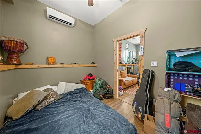 a bedroom with furniture and a flat screen tv
