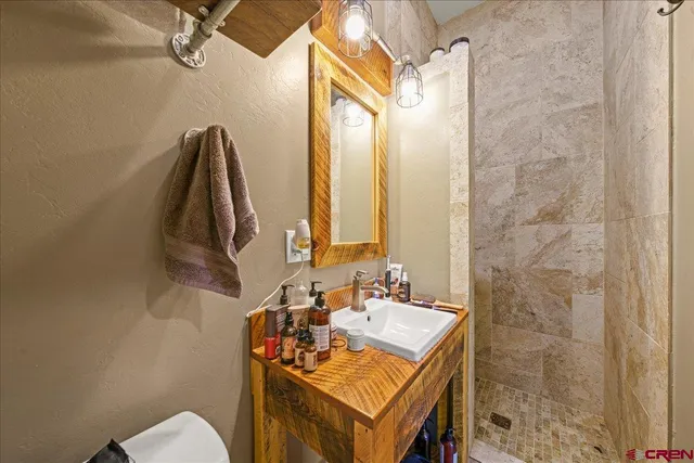 a bathroom with a sink vanity and a mirror