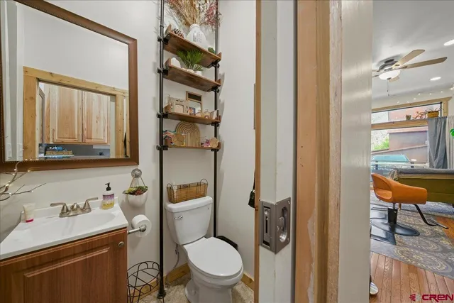 a bathroom with a toilet a sink and a mirror