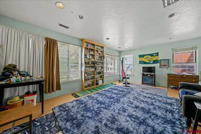 a living room with furniture a window and gym equipment