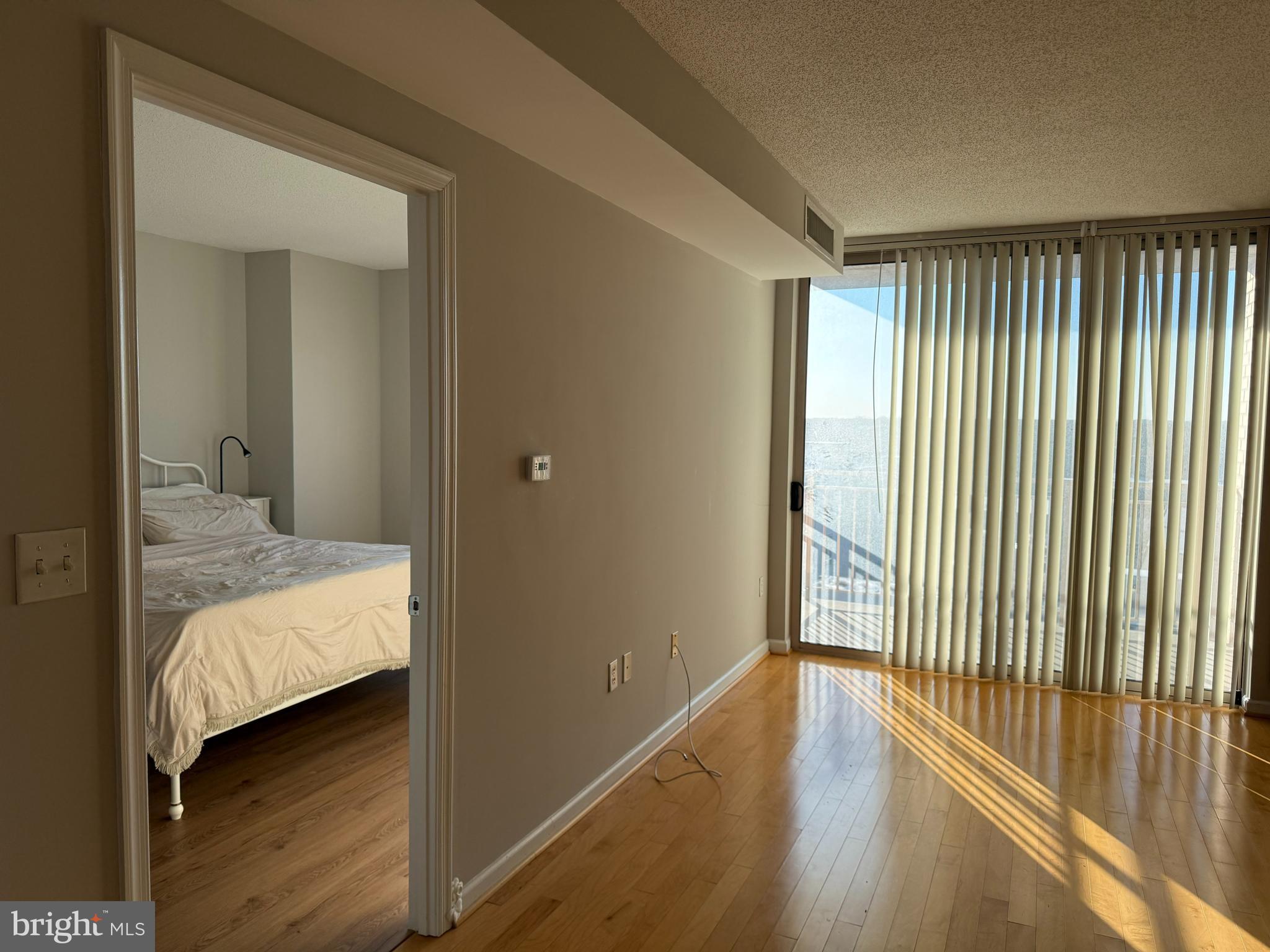 2726 Gallows Road, Unit 915 Vienna, VA 22180 - Photo 13 of 32 a bedroom with a bed and wooden floor