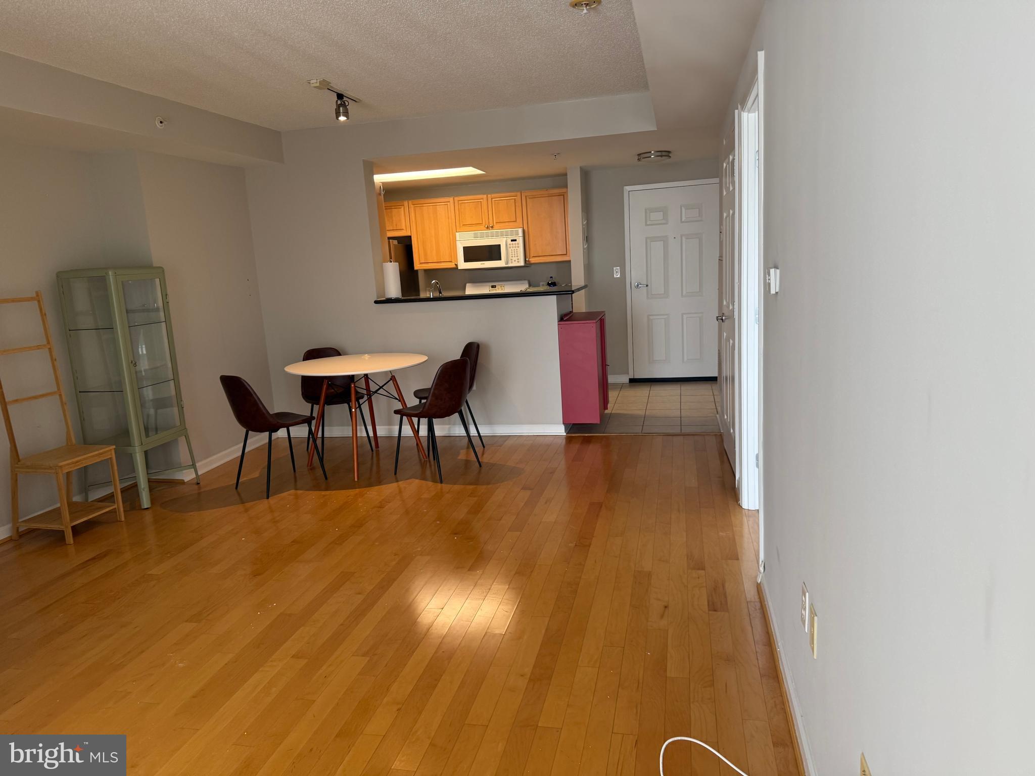 2726 Gallows Road, Unit 915 Vienna, VA 22180 - Photo 4 of 32 a view of a dining room with furniture and wooden floor