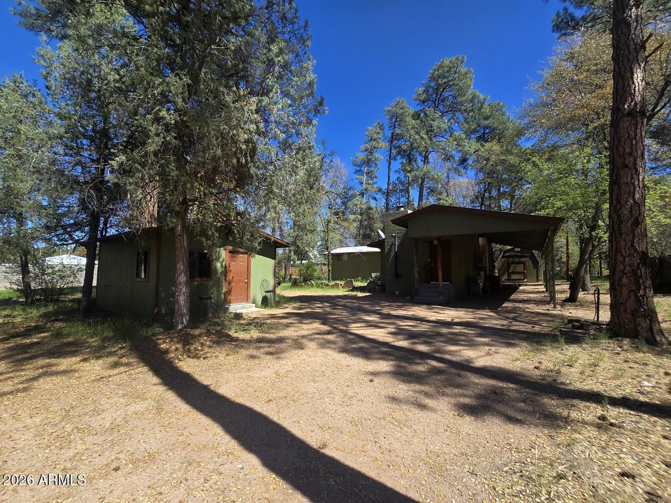 a view of a house with backyard and trees