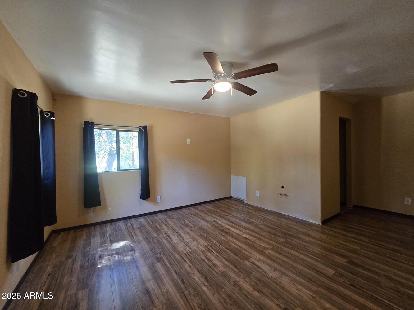 118 East Frontier Street Payson, AZ 85541 - Photo 14 of 22 a view of empty room with wooden floor and fan