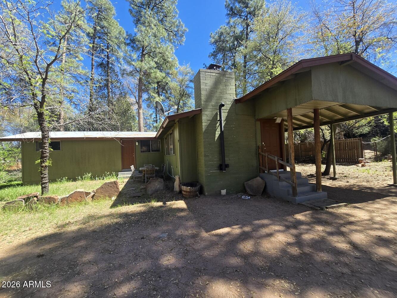 118 East Frontier Street Payson, AZ 85541 - Photo 2 of 22 a view of backyard with a table and chairs under an umbrella