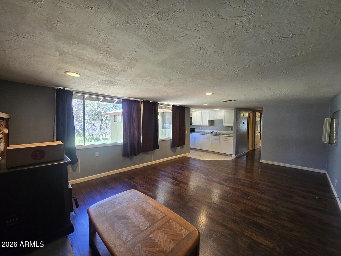 118 East Frontier Street Payson, AZ 85541 - Photo 3 of 22 an empty room with wooden floor and windows