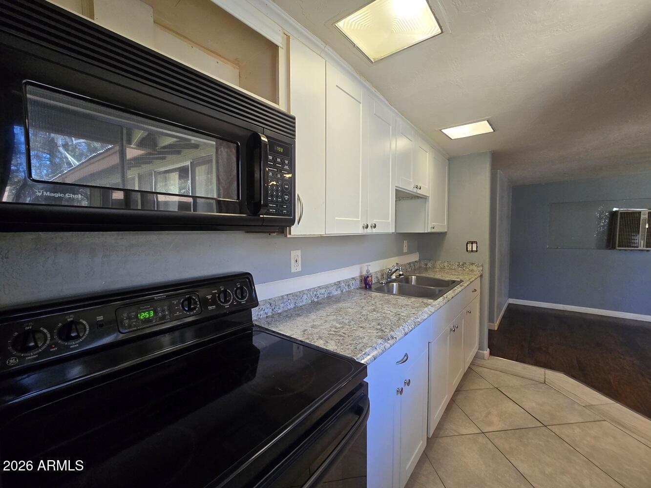 118 East Frontier Street Payson, AZ 85541 - Photo 6 of 22 a kitchen with a stove microwave and cabinets