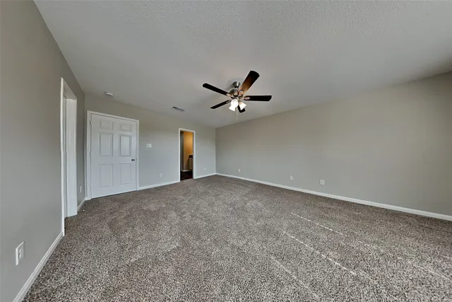 a view of a livingroom with a ceiling fan and window